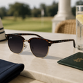 Sunglasses on a table with a blurred outdoor background